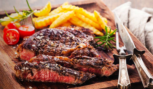 Grilled steak seasoned with Mile High Steak Rub, sliced on a board