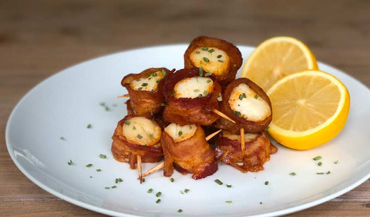 Bacon-wrapped scallops with a curry brown sugar glaze on toothpicks