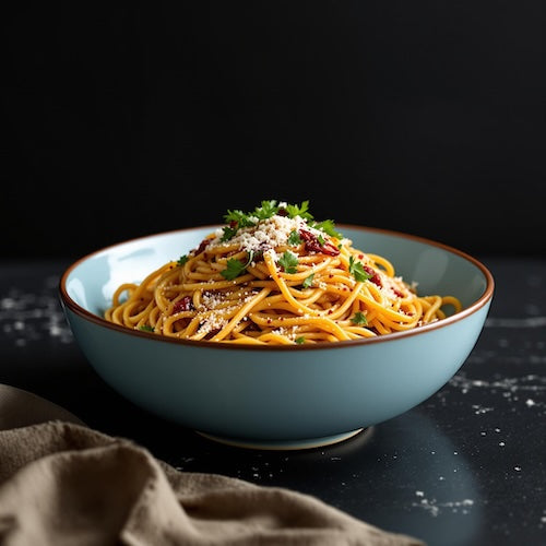 Spaghetti tossed in garlic butter and chili crisp, topped with Parmesan