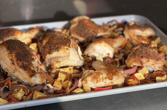 Sheet pan of crispy Moroccan-spiced chicken with roasted chickpeas, sweet peppers and red onion
